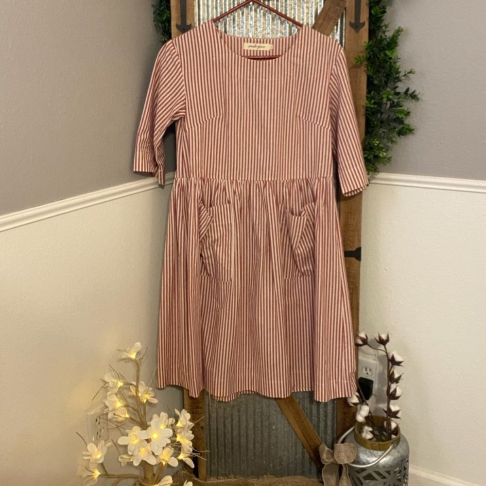 Red and cream striped dress with pockets.